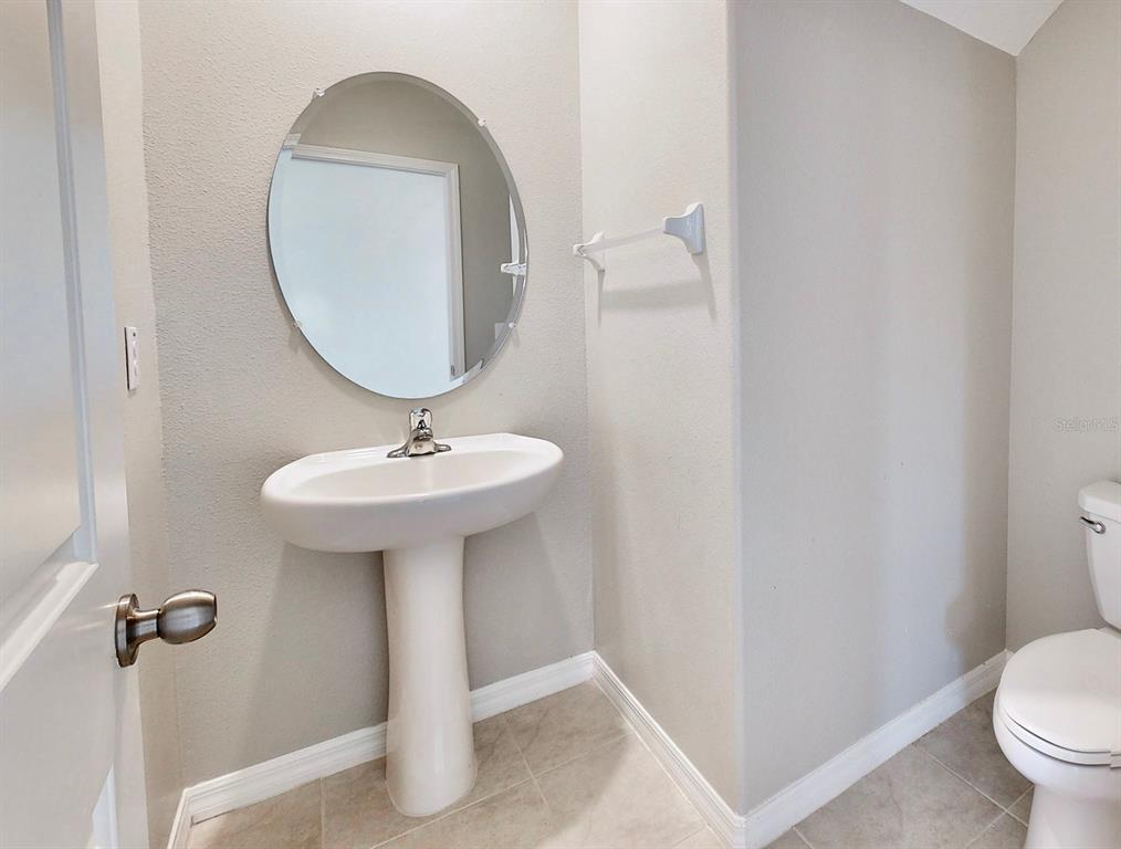 3059 Nubbin Ridge Lane Zephyrhills, FL 33540 - Photo 12 of 22 a bathroom with a sink toilet and a mirror