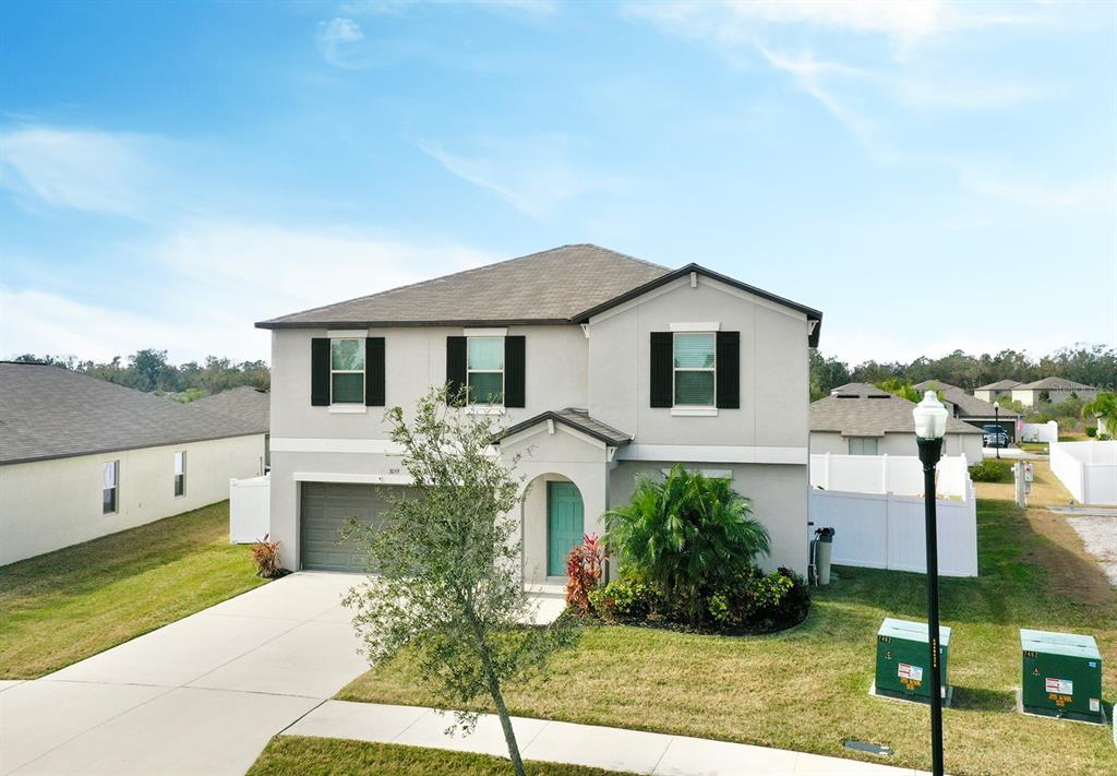 3059 Nubbin Ridge Lane Zephyrhills, FL 33540 - Photo 22 of 22 a front view of a house with garden