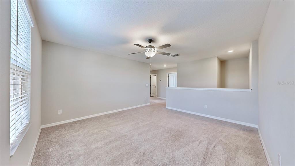 3059 Nubbin Ridge Lane Zephyrhills, FL 33540 - Photo 9 of 22 a view of an empty room with a window