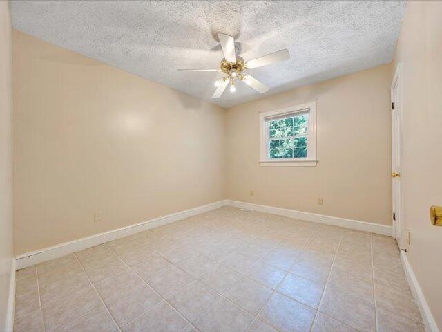 5828 Henry Road Henry, VA 24102 - Photo 15 of 58 an empty room with a window and a fan