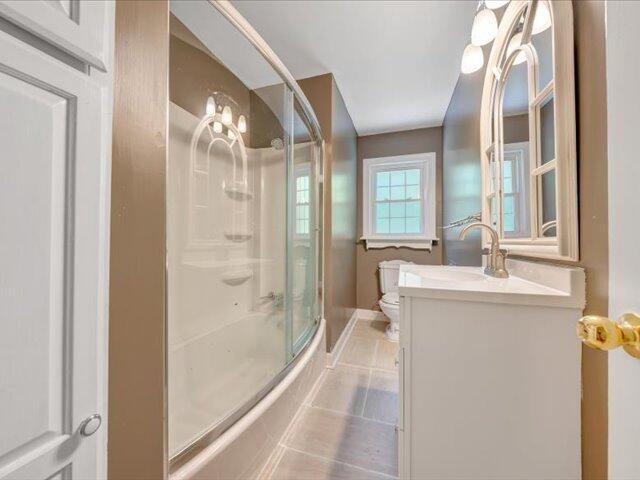 5828 Henry Road Henry, VA 24102 - Photo 17 of 58 a bathroom with a granite countertop sink a mirror and a shower