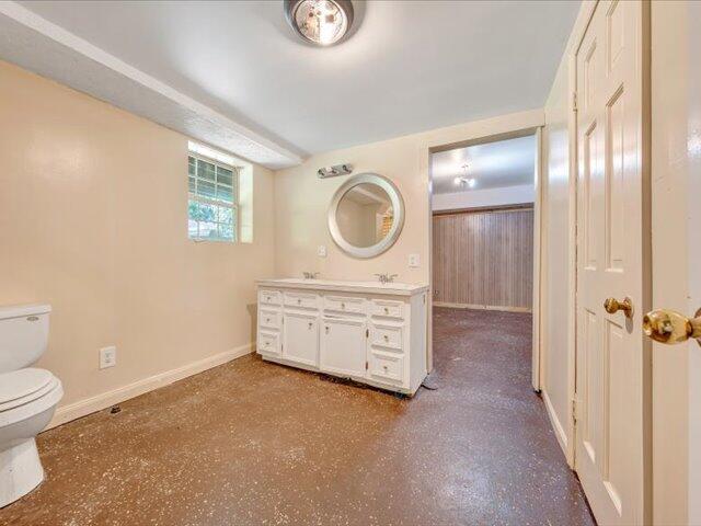 5828 Henry Road Henry, VA 24102 - Photo 32 of 58 a bathroom with a granite countertop sink a toilet and a mirror