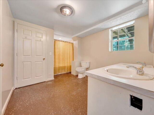5828 Henry Road Henry, VA 24102 - Photo 33 of 58 a bathroom with a sink a toilet and a window