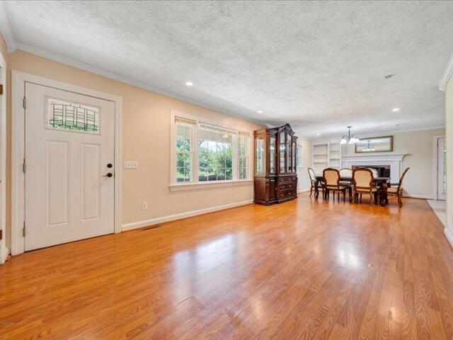5828 Henry Road Henry, VA 24102 - Photo 4 of 58 an empty room with wooden floor and windows