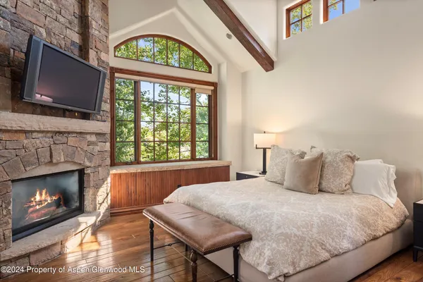 a bedroom with a bed and a fireplace