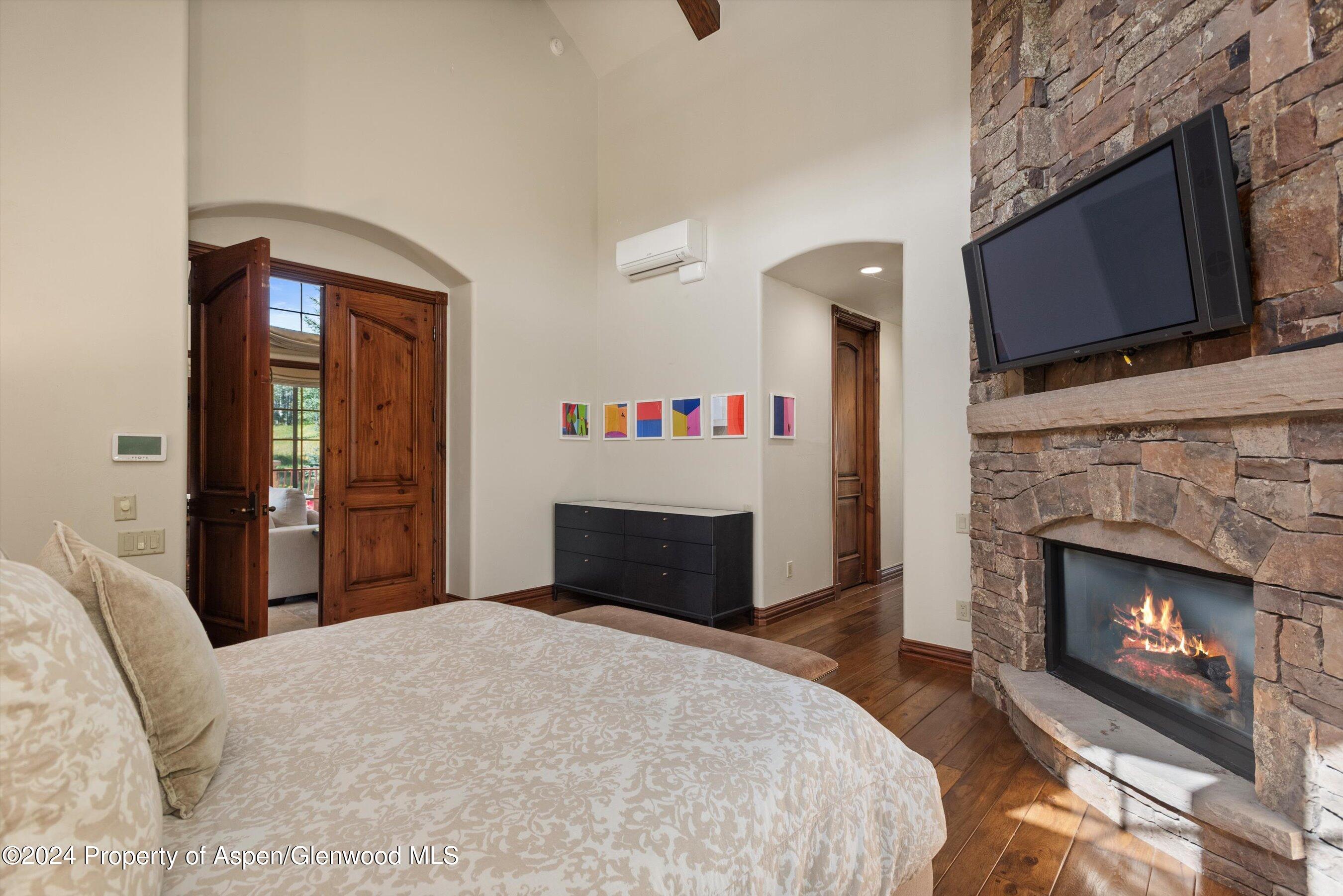 71 Meadow Road Snowmass Village, CO 81615 - Photo 13 of 48 a bedroom with a bed and a fireplace