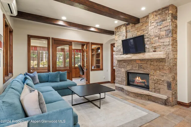 a living room with furniture fireplace and flat screen tv