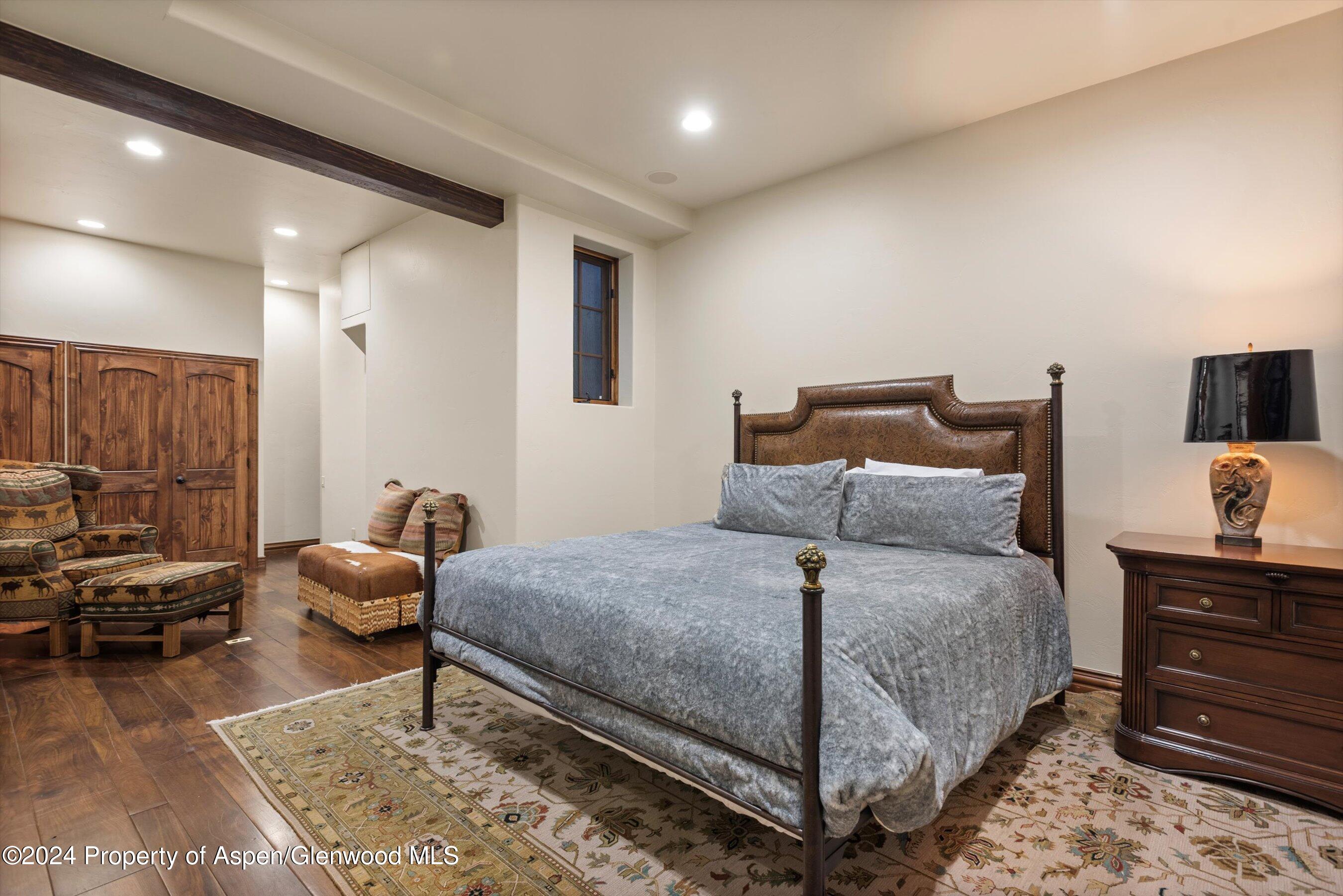 71 Meadow Road Snowmass Village, CO 81615 - Photo 26 of 48 a bedroom with a bed and furniture