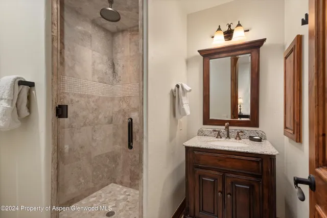a bathroom with a sink vanity and a mirror