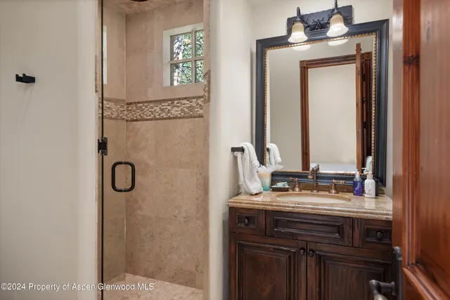 a bathroom with a sink vanity and a mirror