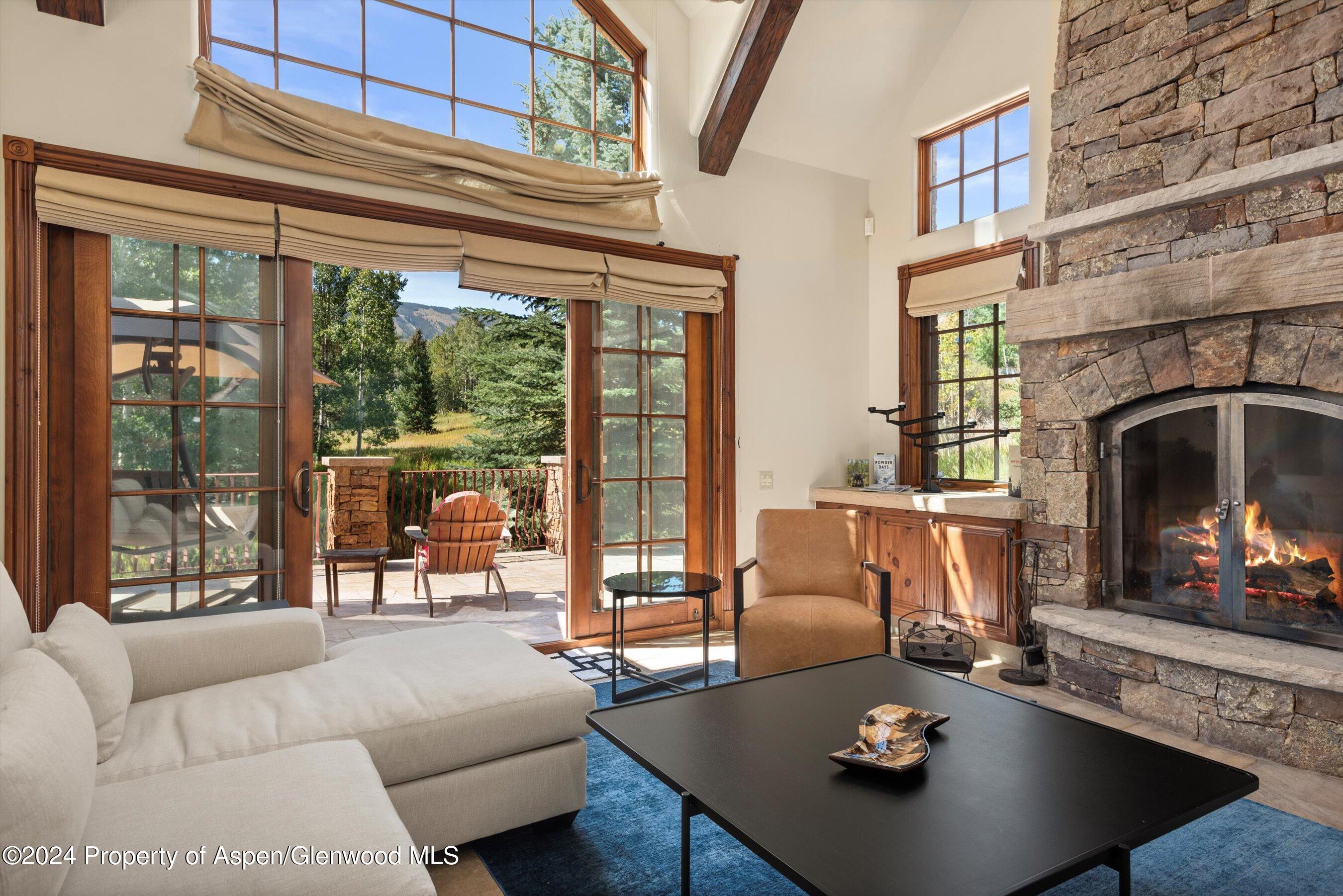 71 Meadow Road Snowmass Village, CO 81615 - Photo 4 of 48 a living room with furniture and a fireplace