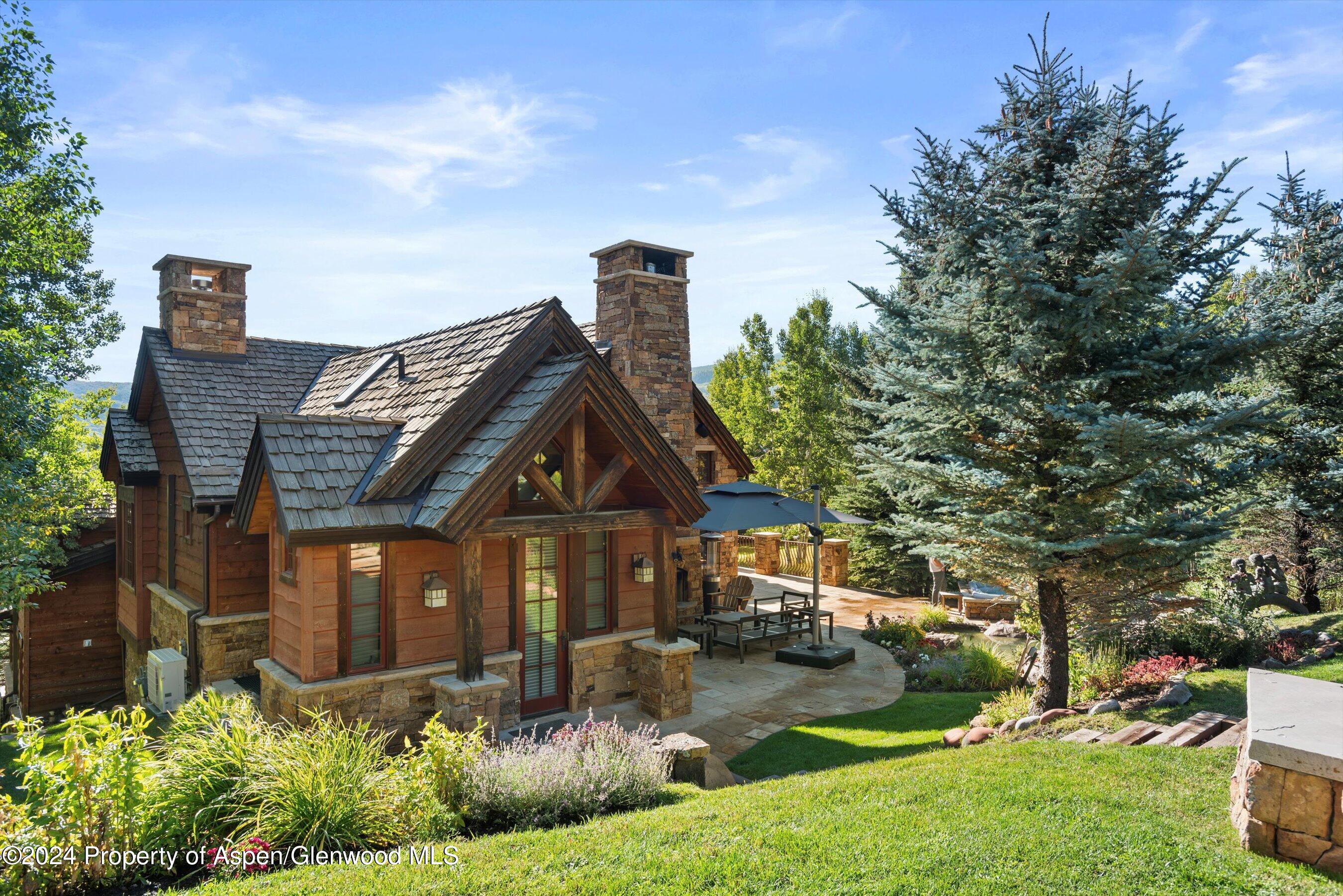 71 Meadow Road Snowmass Village, CO 81615 - Photo 42 of 48 a front view of a house with garden