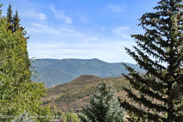 a view of mountain with sunset