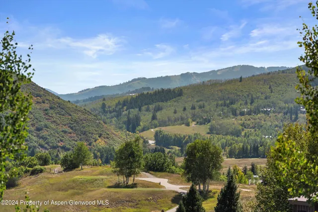 a view of a town with mountains in the background