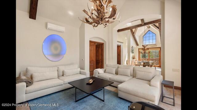 71 Meadow Road Snowmass Village, CO 81615 - Photo 5 of 48 a living room with furniture a chandelier and a large mirror