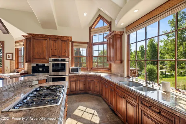 a kitchen with stainless steel appliances a stove a sink and a microwave