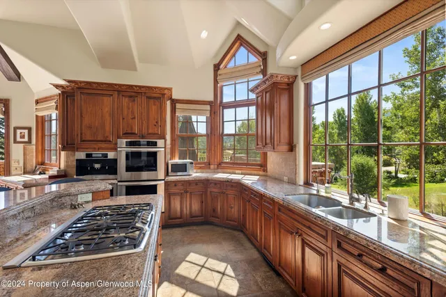 a kitchen with stainless steel appliances a stove a sink and a microwave