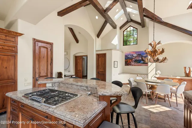 a view of a dining room with furniture and a chandelier