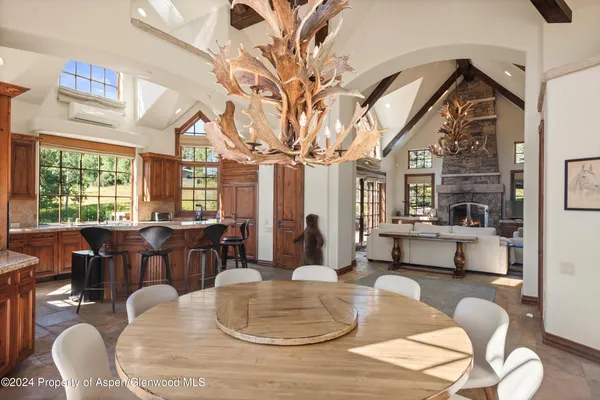 a living room with fireplace furniture and a large window