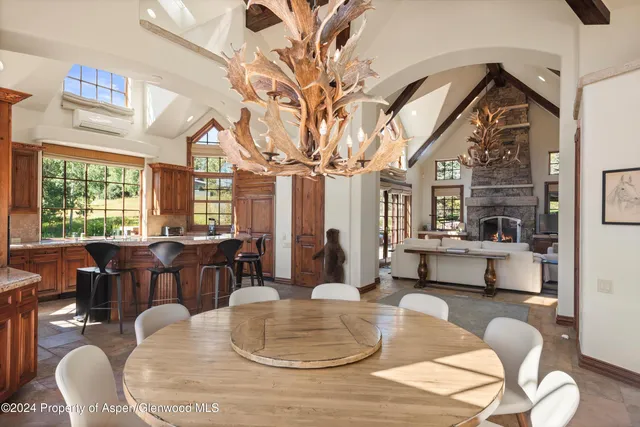 a living room with fireplace furniture and a large window