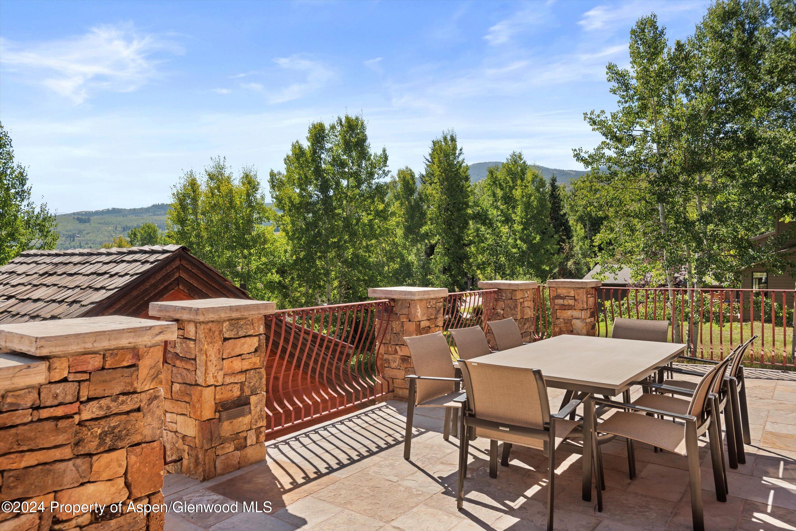 71 Meadow Road Snowmass Village, CO 81615 - Photo 10 of 48 a view of a chairs and table on the terrace