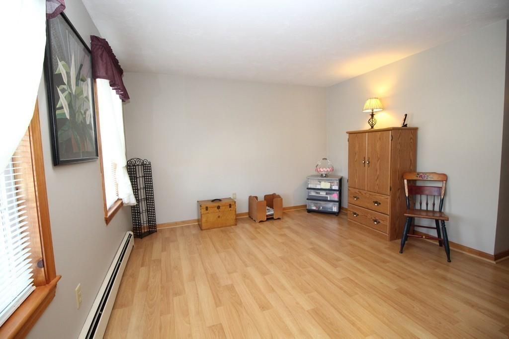 69 Bear Hill Road Gardner, MA 01440 - Photo 16 of 41 a bed room with a bed and a chair