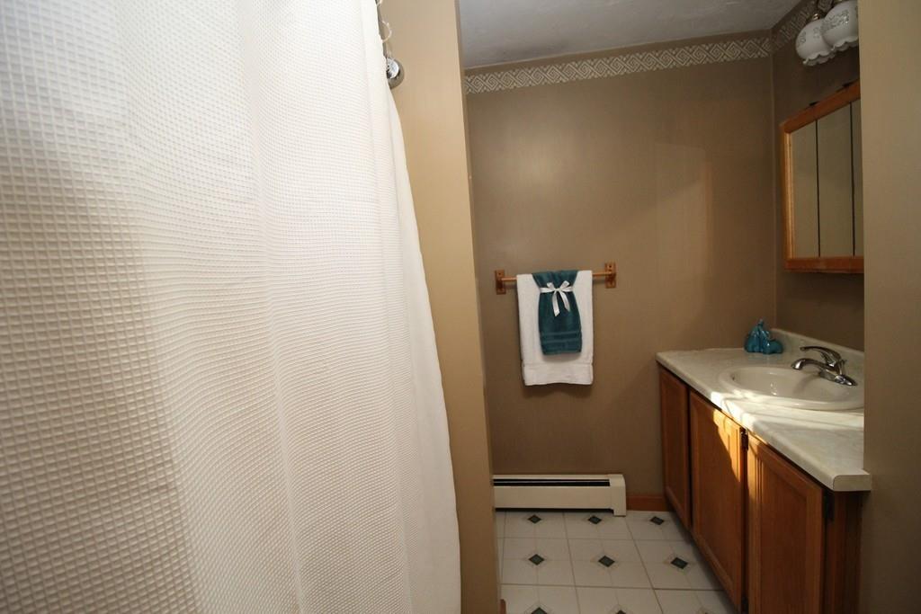 69 Bear Hill Road Gardner, MA 01440 - Photo 25 of 41 a bathroom with a sink a toilet and mirror
