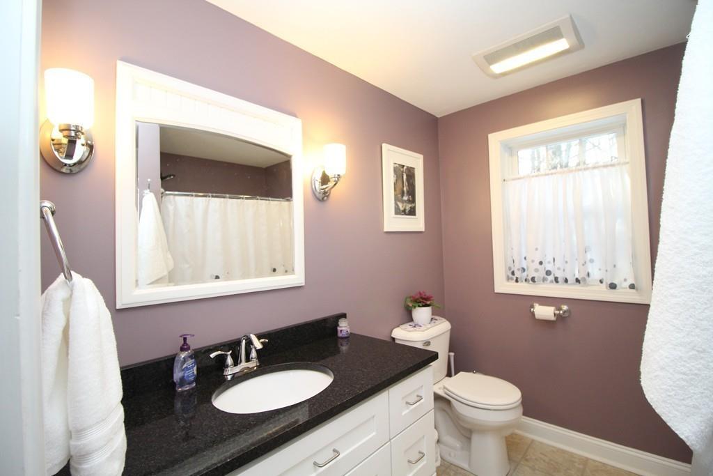 69 Bear Hill Road Gardner, MA 01440 - Photo 31 of 41 a bathroom with a granite countertop sink toilet a mirror and a window