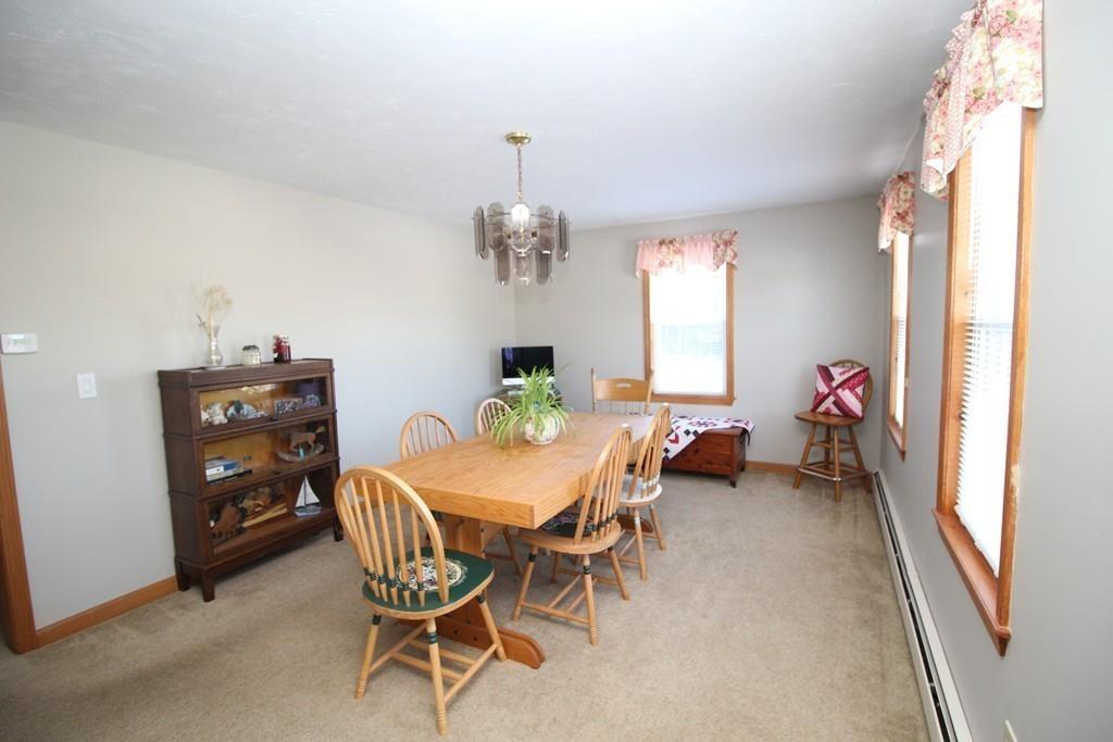 69 Bear Hill Road Gardner, MA 01440 - Photo 5 of 41 a view of a dining room with furniture and a chandelier