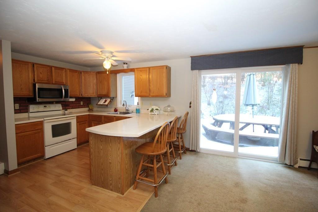 69 Bear Hill Road Gardner, MA 01440 - Photo 7 of 41 a kitchen that has a sink a stove and a refrigerator