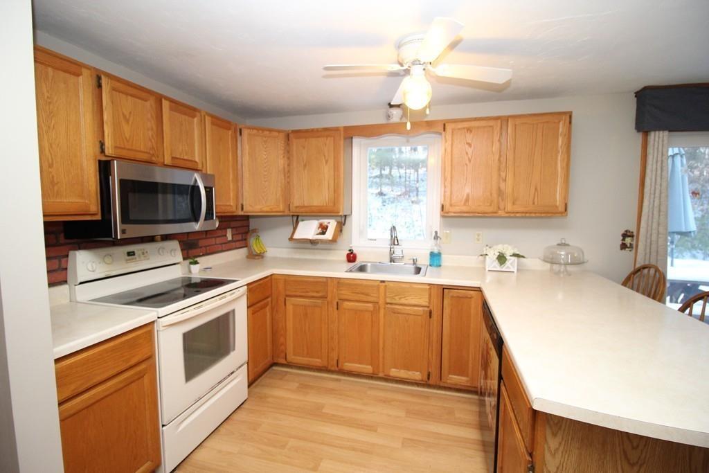 69 Bear Hill Road Gardner, MA 01440 - Photo 8 of 41 a kitchen with a stove a sink and a microwave