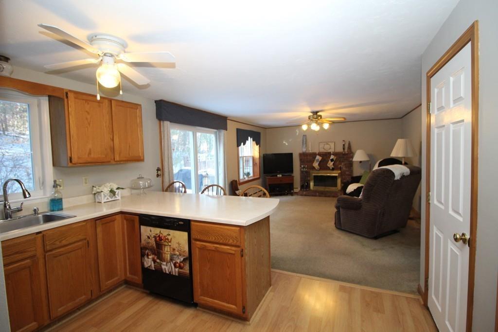 69 Bear Hill Road Gardner, MA 01440 - Photo 10 of 41 a kitchen with a sink dishwasher a stove and a refrigerator with wooden floor