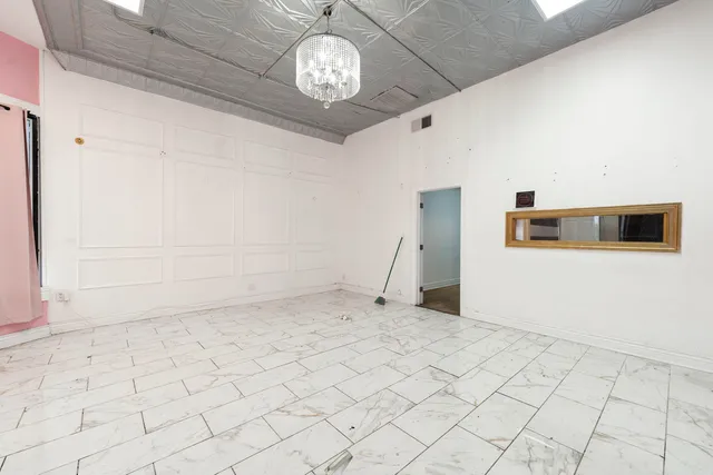 a view of a livingroom with a dishwasher and furniture