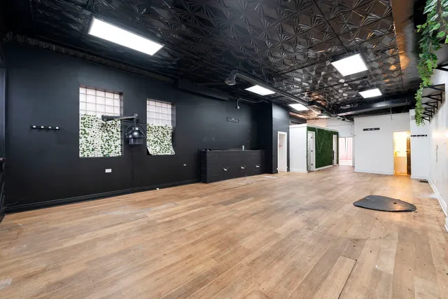 a spacious bathroom with a granite countertop sink and a large mirror