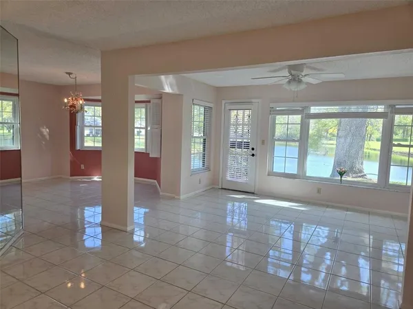a dining room with furniture a chandelier and wooden floor