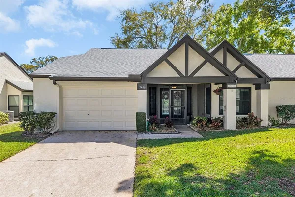 a front view of a house with a yard outdoor seating and garage