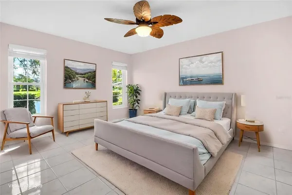 a front view of a house with a yard and palm trees