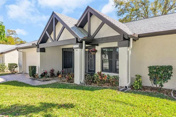 a view of a hallway with wooden floor and a living room