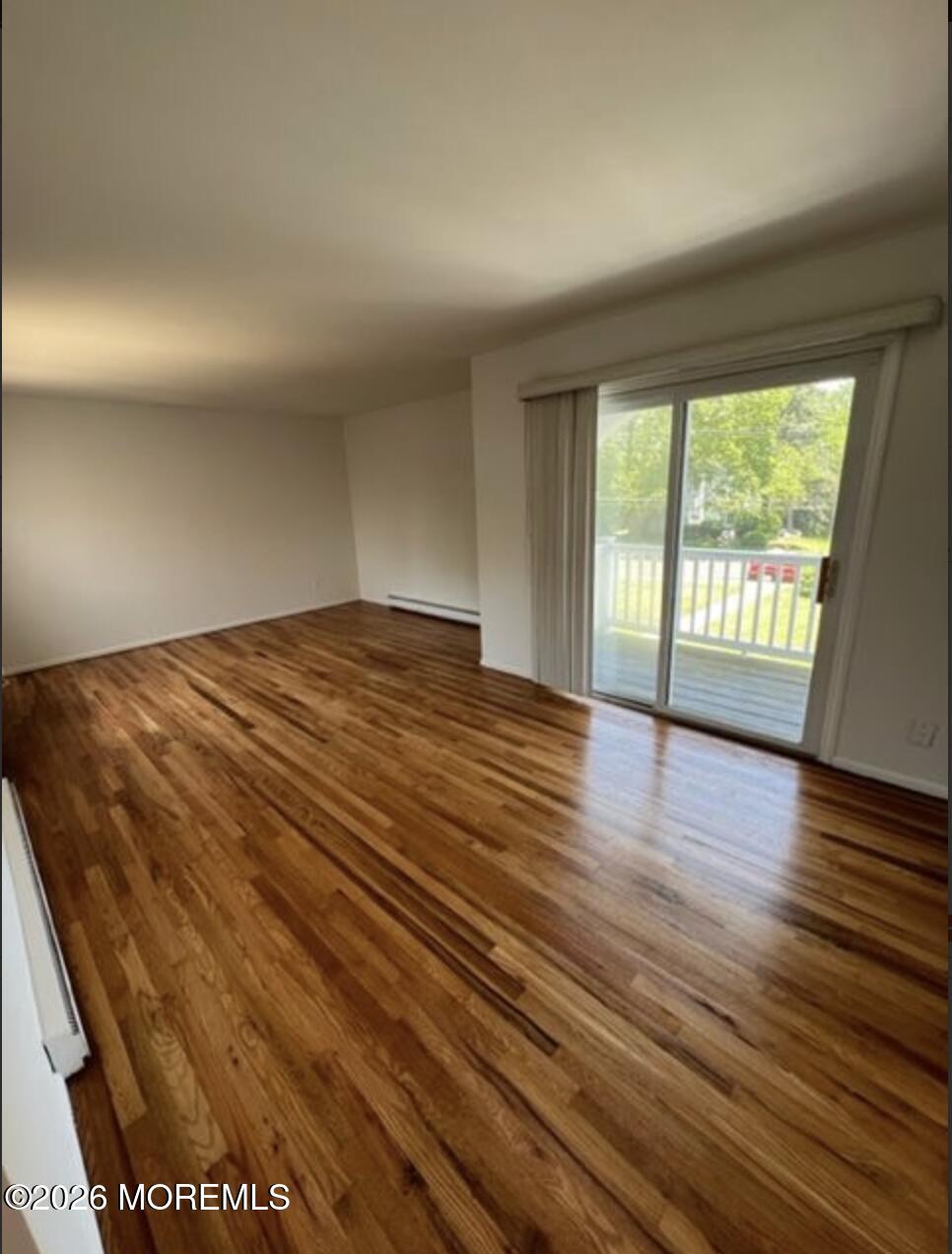 711 Wall Road, Unit 14 Spring Lake Heights, NJ 07762 - Photo 2 of 8 a view of an empty room with wooden floor and a window