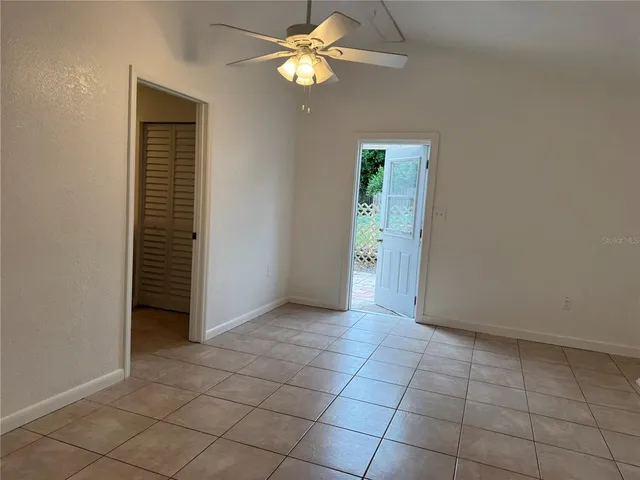 a view of a kitchen with kitchen island a sink stainless steel appliances wooden floor and cabinets