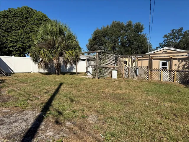 a view of a house with a yard and sitting area