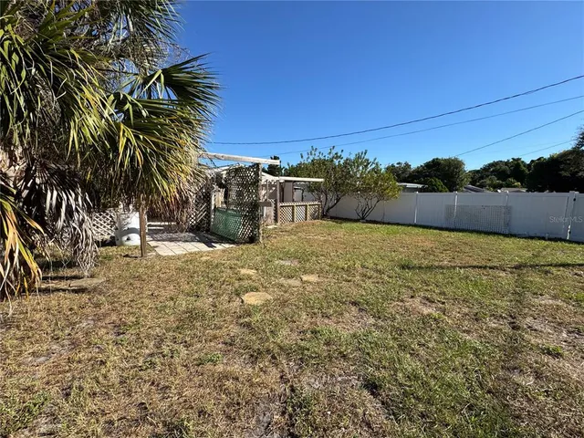 a view of a backyard with sitting area