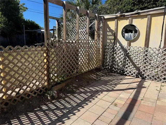 a bedroom with a bed and a chandelier fan