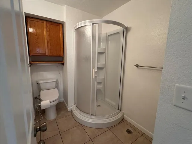 a view of a kitchen with furniture and an empty room
