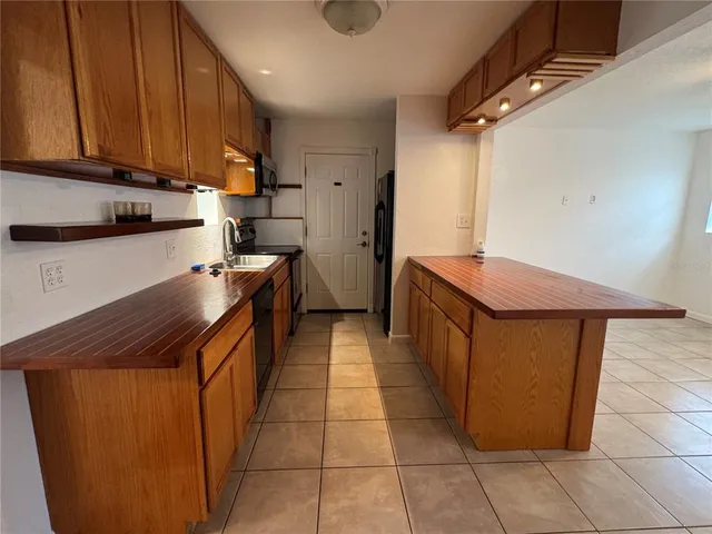 a kitchen with stainless steel appliances granite countertop a stove and a refrigerator