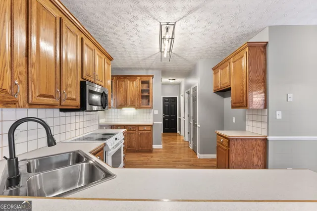 an empty room with a ceiling fan and window