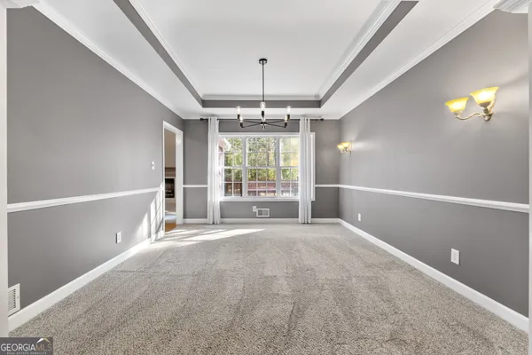a spacious bathroom with a granite countertop sink and a mirror