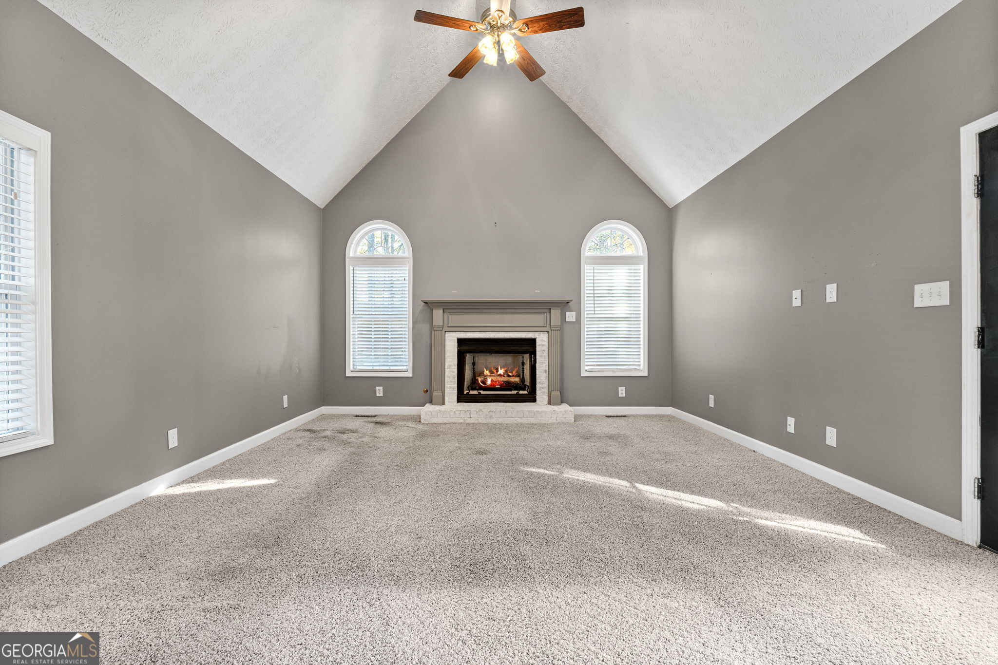 400 Moseley Road Stockbridge, GA 30281 - Photo 18 of 70 a view of an empty room with a fireplace and a window