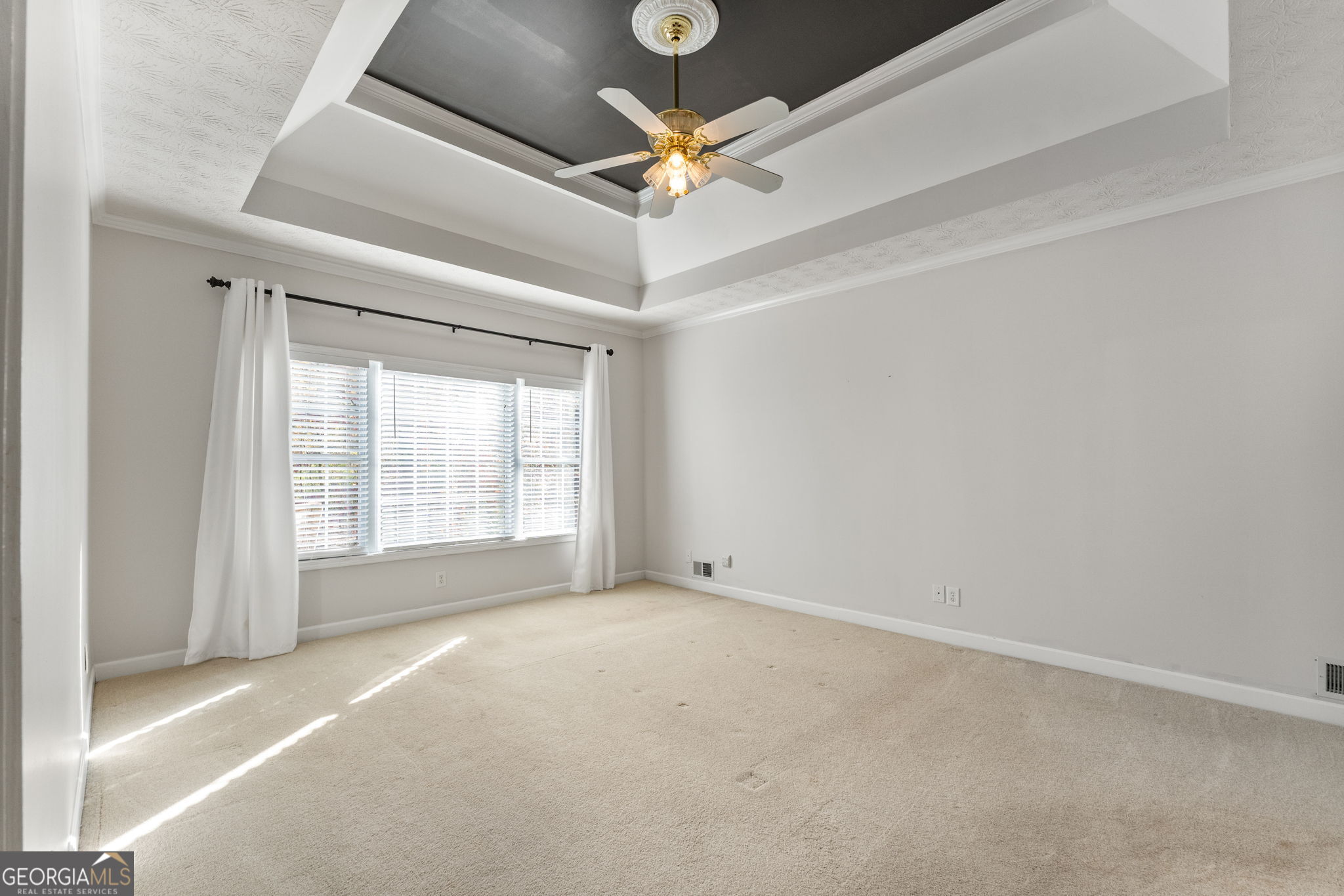 400 Moseley Road Stockbridge, GA 30281 - Photo 20 of 70 an empty room with a ceiling fan and window