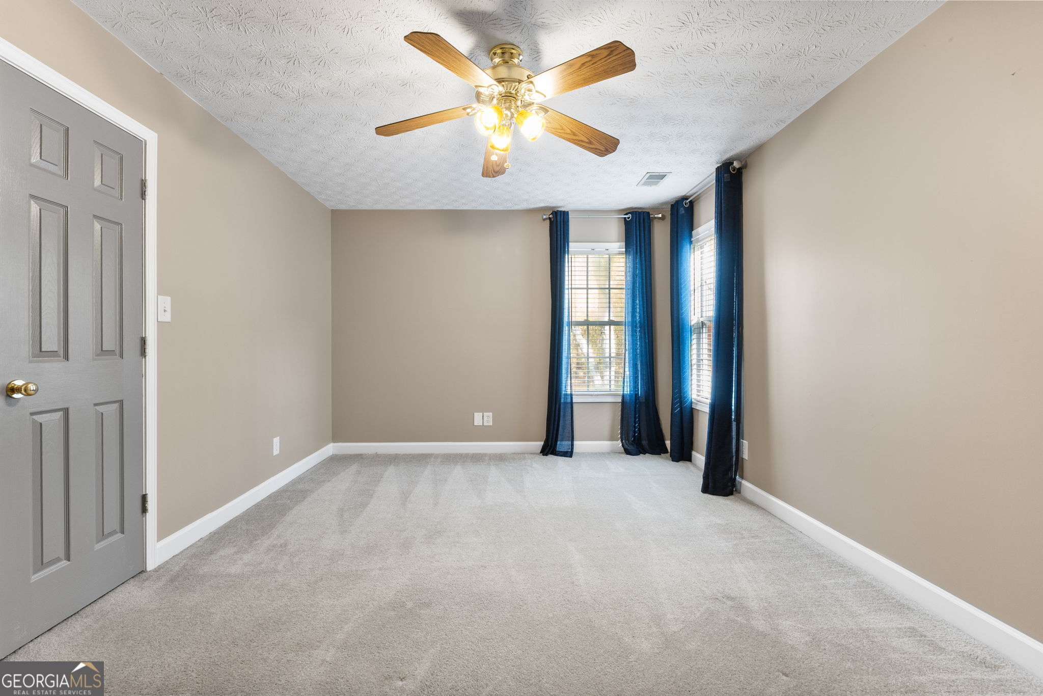 400 Moseley Road Stockbridge, GA 30281 - Photo 34 of 70 an empty room with closet and a chandelier fan